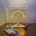 Acrylic DIY LED message board night light on a desk, showing writing on the glowing transparent surface with pens nearby.