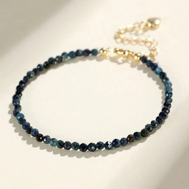Blue tourmaline bracelet with 3mm beads and metal spacer sections on wrist