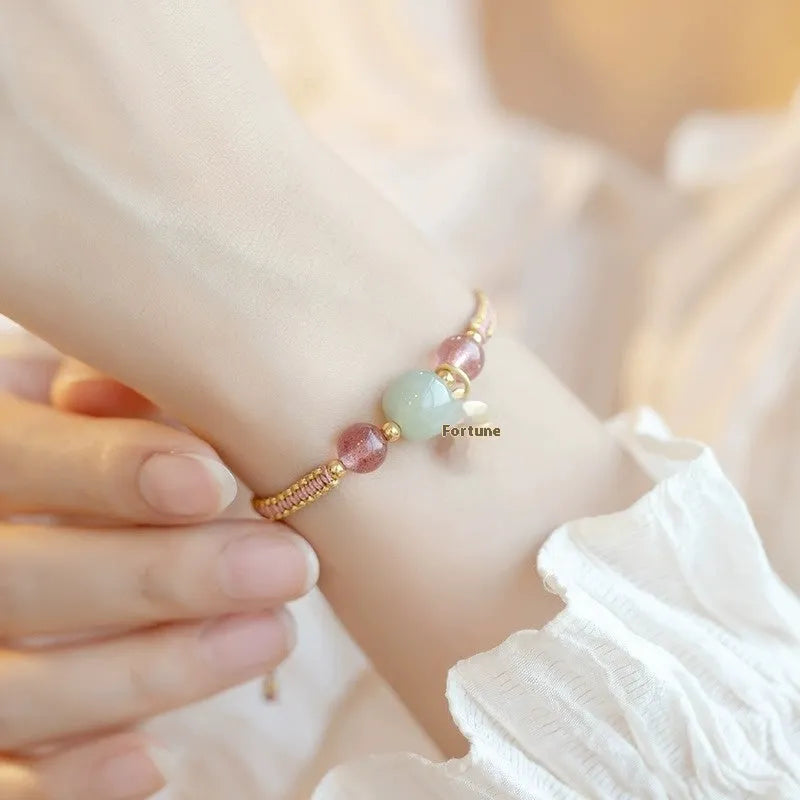 Adjustable red rope bracelet with sliding strawberry quartz bead in national tide style.