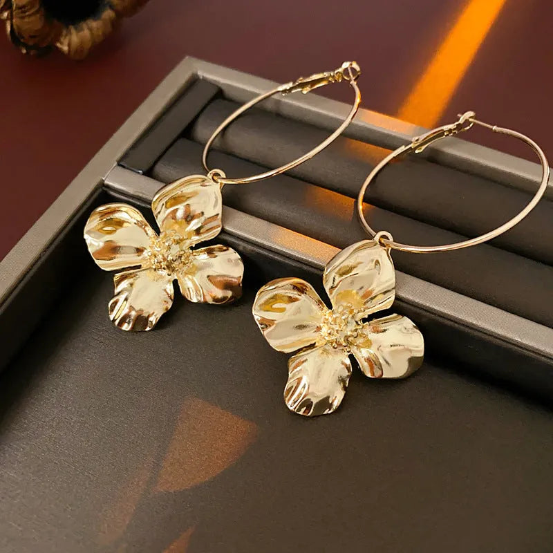 Gold and silver vintage metal flower earrings with geometric design and a silver needle detail.
