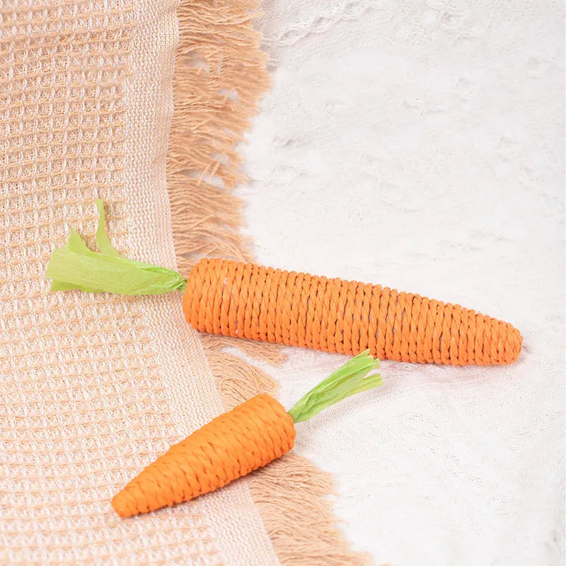 Assortment of interactive cat toys including carrot-shaped paper toys, ringing stones, and cat sticks in two sizes