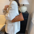 Brown pleated PU baguette shoulder bag showing its vertical square shape and chain strap.
