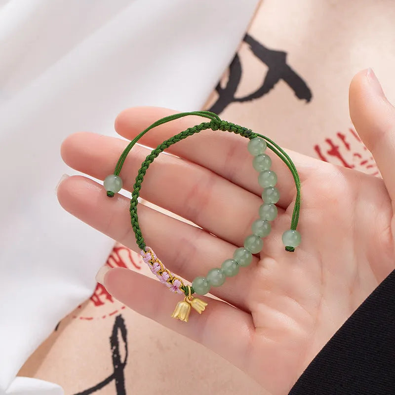 Hand woven red rope bracelet with lily floral design in national style