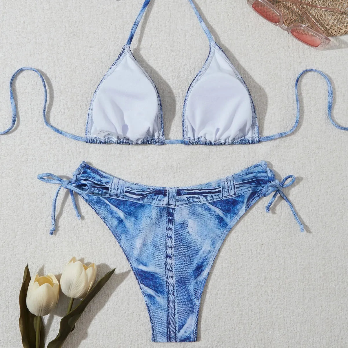 Denim blue printed women's bikini set with strap design on a white background.