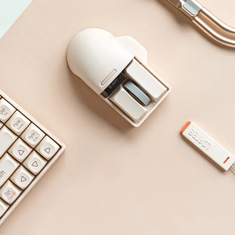 Tofu coloured Xiaoqiao wireless mouse on a desk, showing its ergonomic shape and seven buttons.