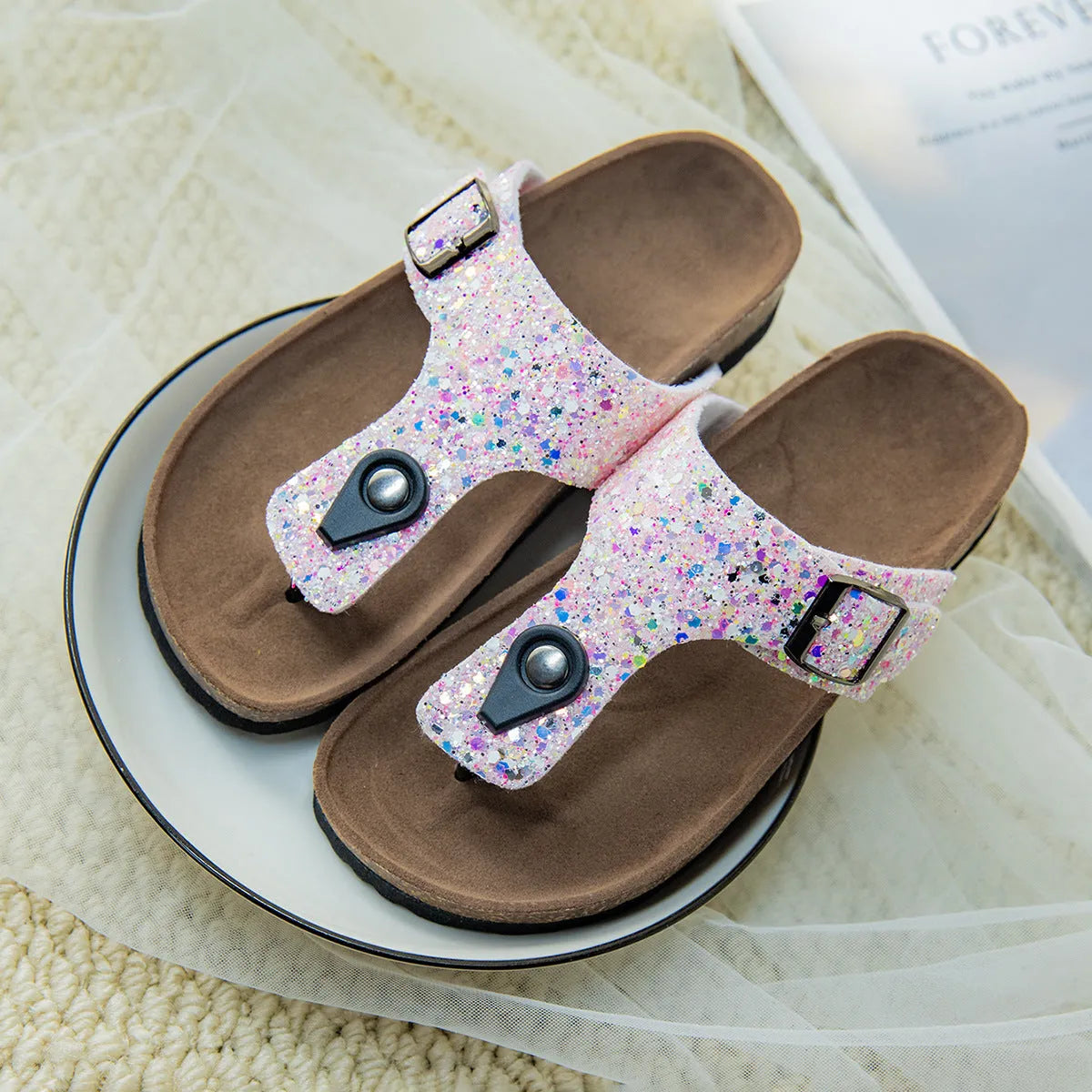 Cork flip-flops in pink, silver, and gold colours with artificial leather uppers and PVC soles