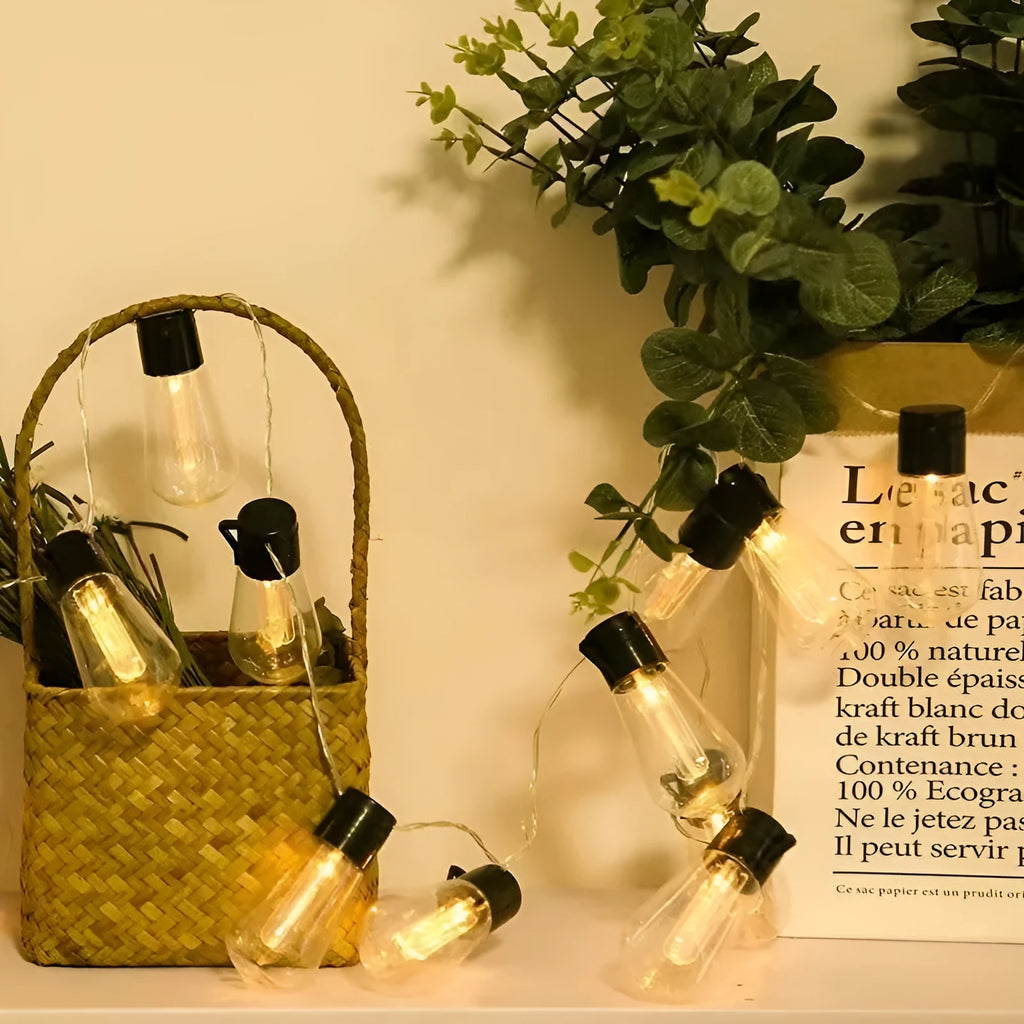 Solar powered outdoor string lights with retro long bulb infusion bottle shapes on 10 metre cable