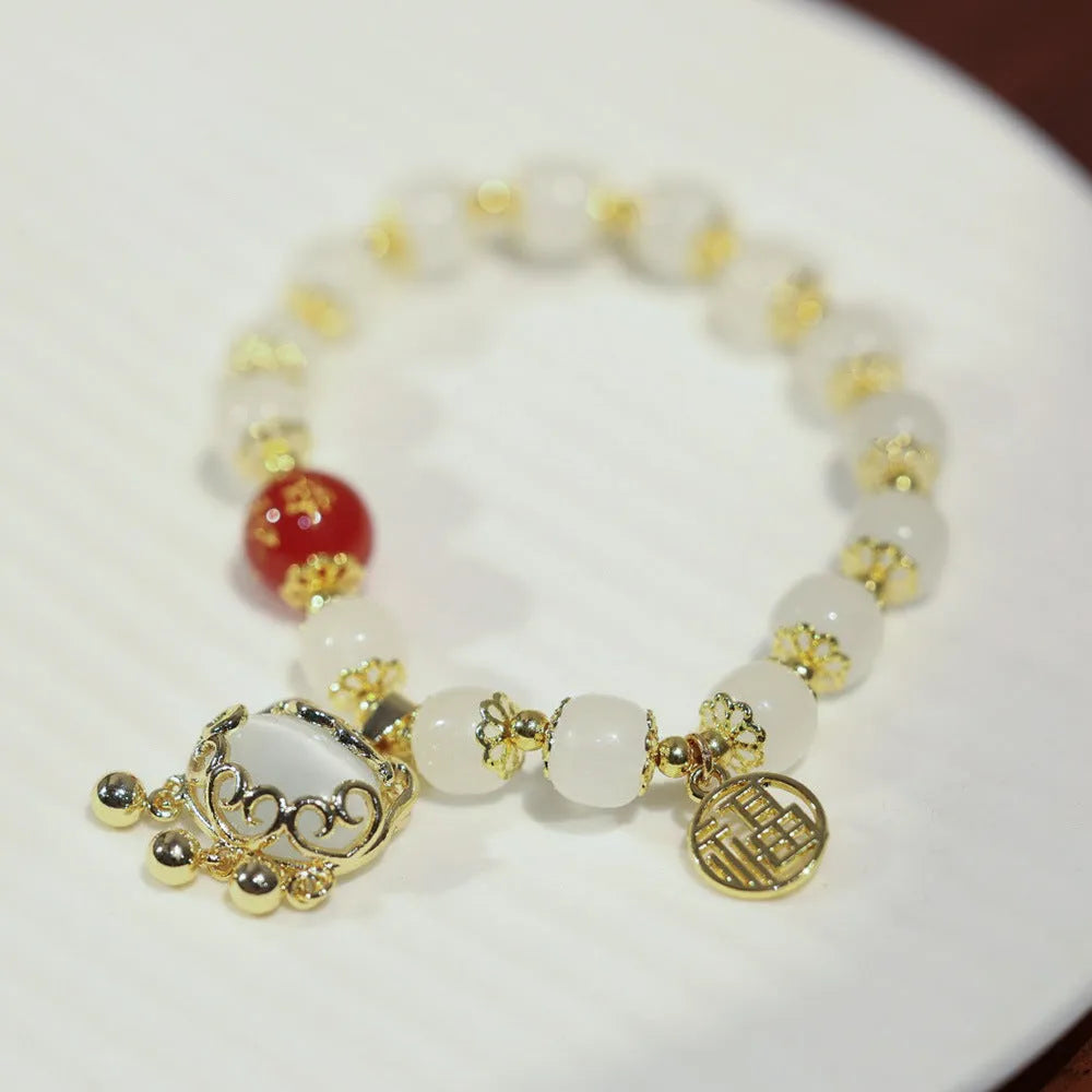 Chinese style women's glass bracelet with fu character and safety lock charms.