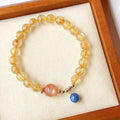 Women's gold rutilated quartz sunstone crystal bracelet with round beads in diamond pattern