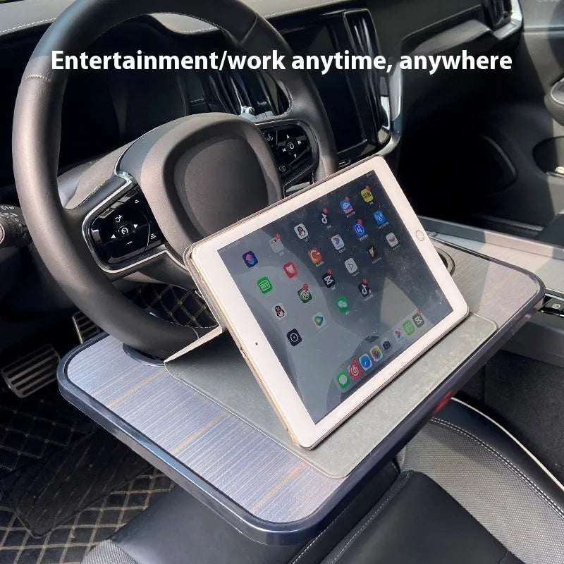 Large black portable car tray with foldable cup holder placed over a steering wheel