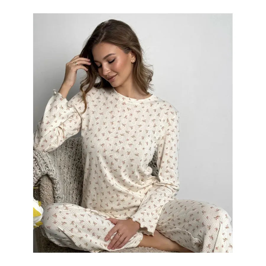 White floral print women's suit with bell sleeve top and wide leg trousers on hanger