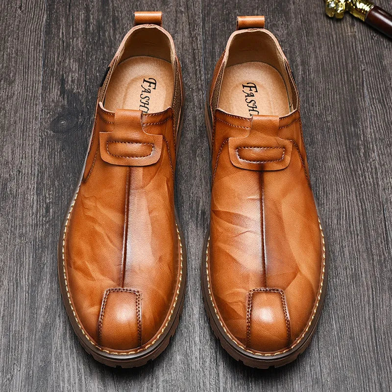 Men's black cowhide leather round toe loafers with rubber sole on a light background