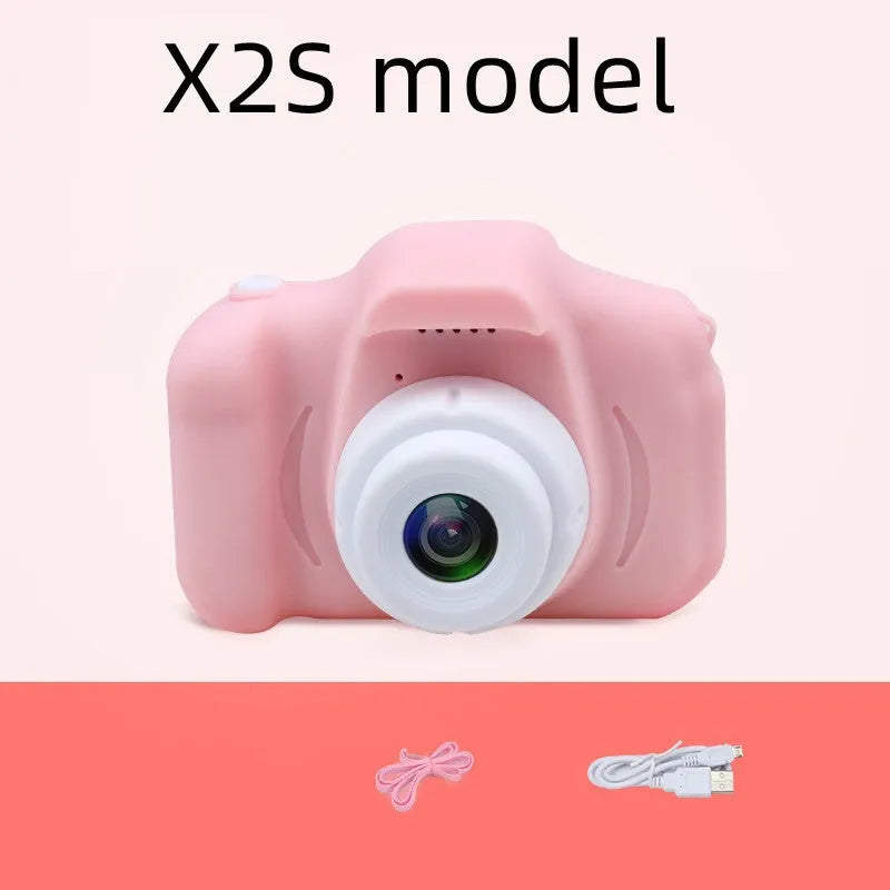 X2 HD mini cartoon kids digital camera in silicone body with 2-inch screen and lanyard.