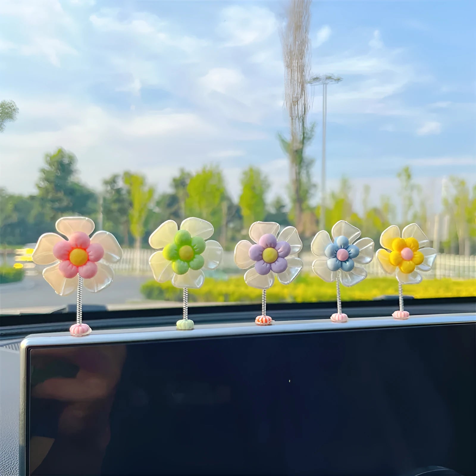 Small colourful plastic car swing decoration ornament for dashboard or shelf.