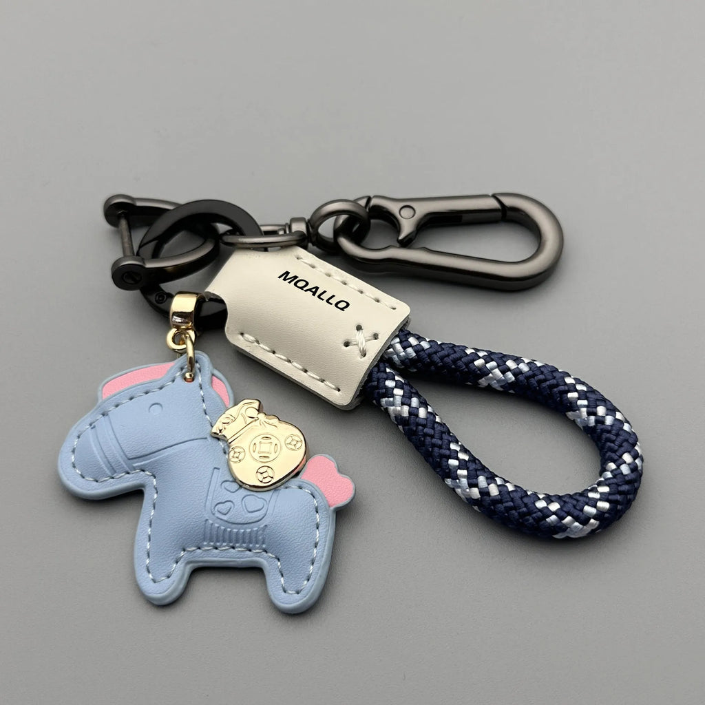 Handmade cowhide car key ring pendant with zinc alloy pony belt buckle charm and flanelle rope in various colours.