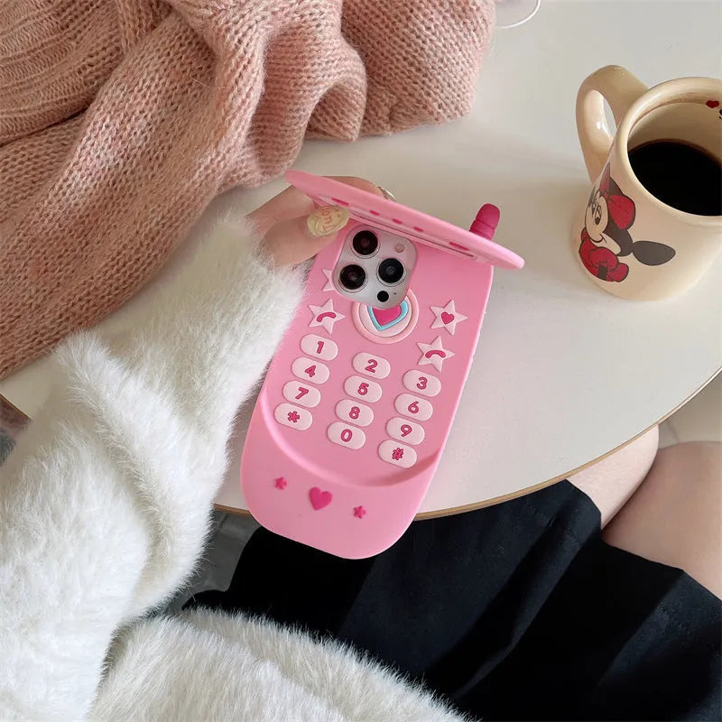Light pink silicone iPhone case with a built-in cosmetic mirror, showing a cute cartoon design.