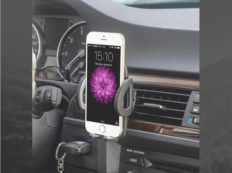 Black plastic mobile phone holder mounted on car air conditioning outlet vent