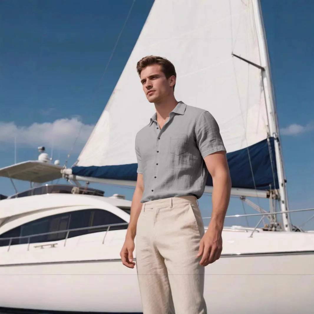 Man wearing a loose-fit, light blue, short-sleeved linen shirt in a cardigan style.