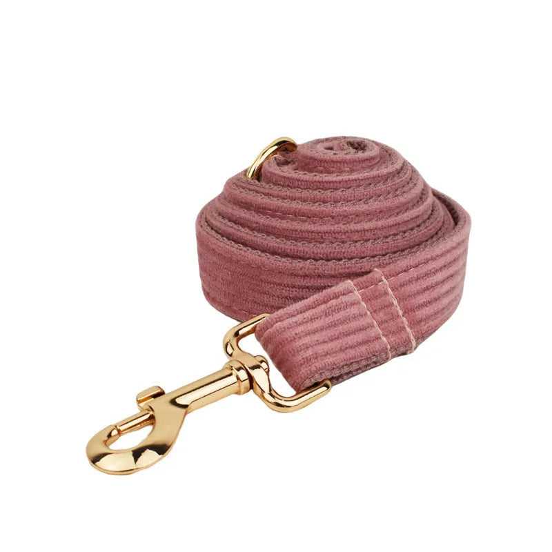 Red corduroy dog collar and matching traction rope set with vest, bow, and poop bag accessories