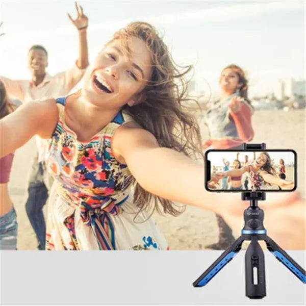Black aluminium alloy and plastic desktop tripod stand holding a mobile phone.