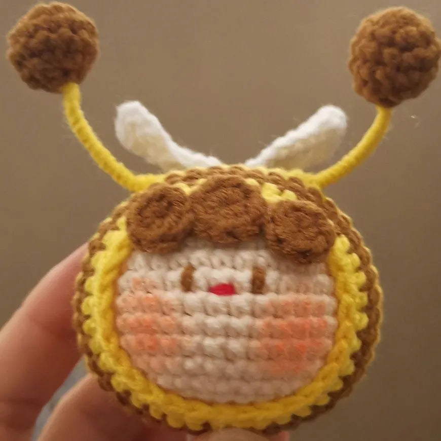 Handmade crocheted bee colony pendant accessory for a woolen doll.