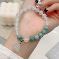 Close-up of a women's retro Chinese style agate lotus seedpod bracelet on an adjustable strap.