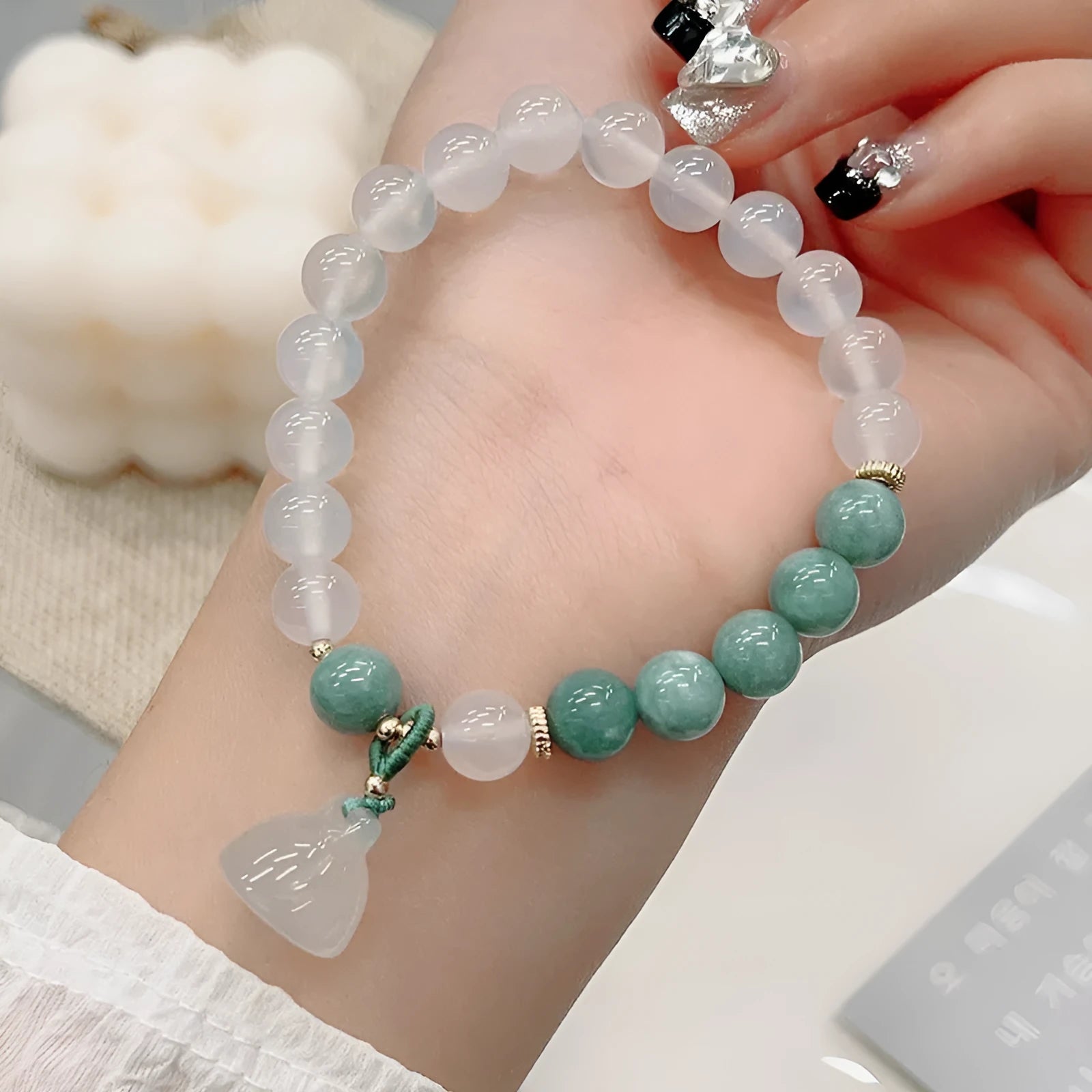 Close-up of a women's retro Chinese style agate lotus seedpod bracelet on an adjustable strap.