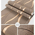 Close-up of dark brown curve stripe 3D wallpaper with a textured velvet surface.