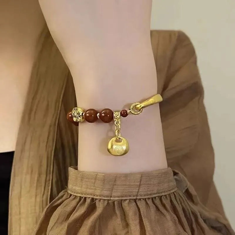 Golden south red agate character ingot women's bracelet with lucky bag design