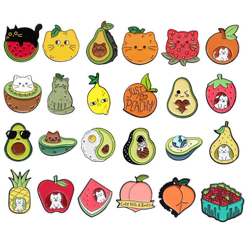 Colourful cartoon fruit design metal brooch pin on a fabric background.