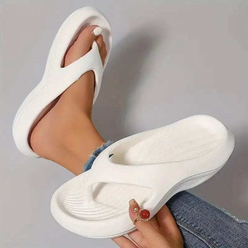 Black women's flip-flops with thick sole and textured non-slip tread.
