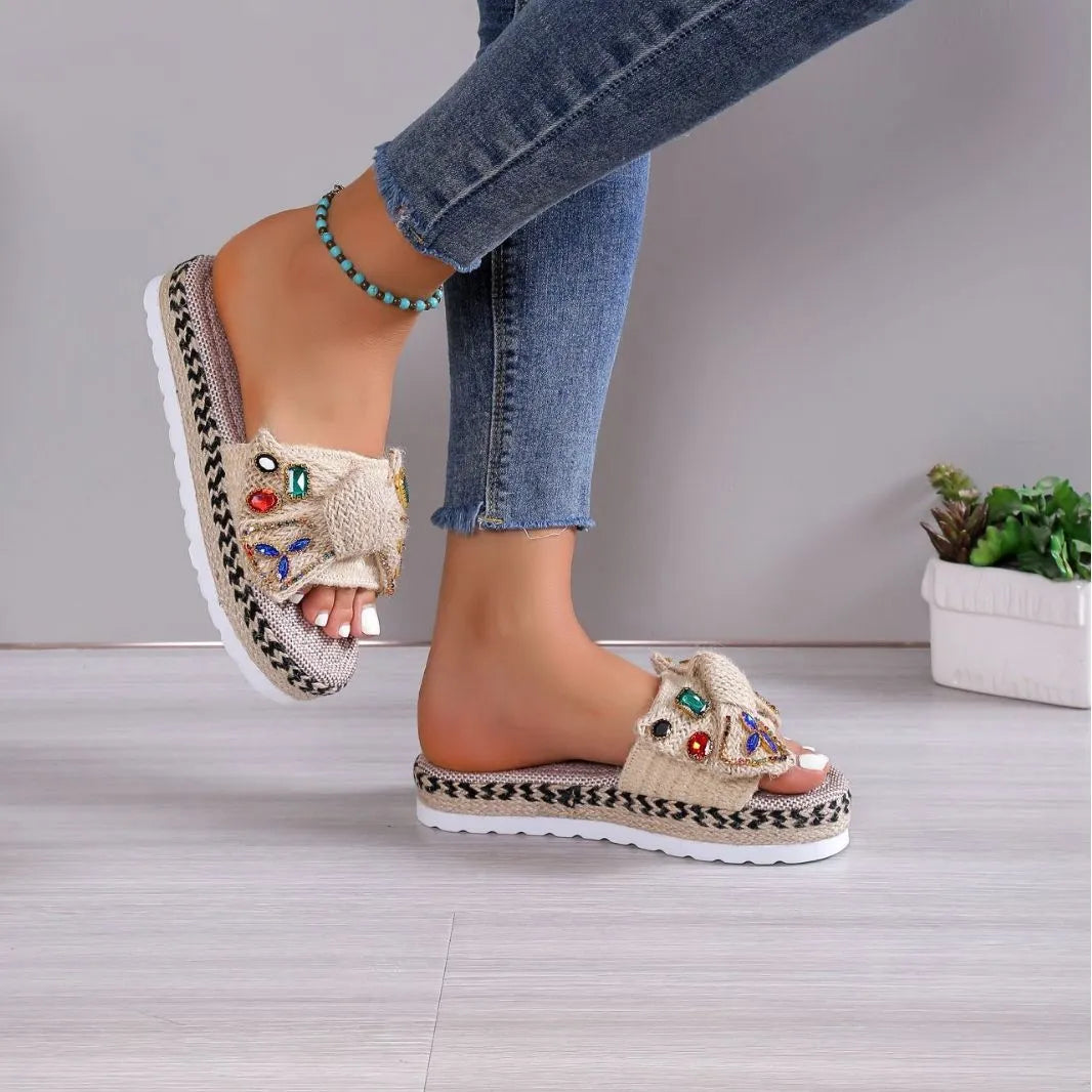 Creamy-white women's platform sandals with a cloth upper, beach bow detail, and slip-on sleeve design.