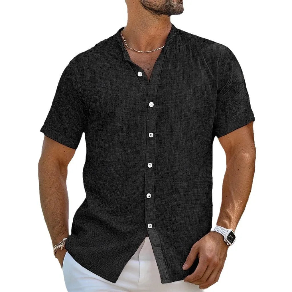 Man wearing a light blue loose fit cotton linen short sleeve cardigan shirt with a Henry collar.