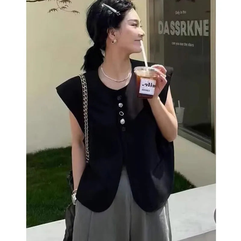 Women's loose fit polyester vest in milky white with a pocket detail and short 40cm length.