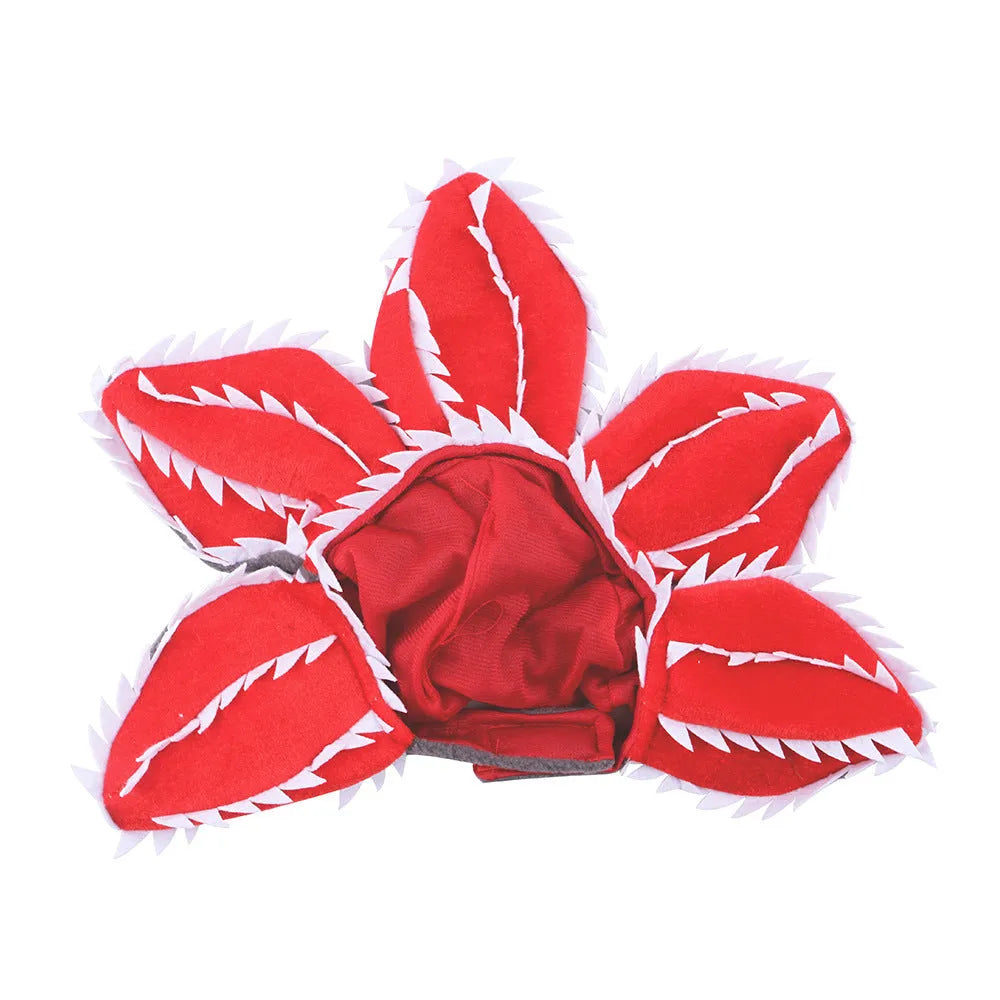 Medium dog wearing Halloween costume with demon hat flower headband and chomper style top