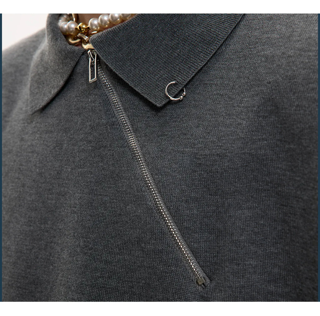 Men's slim-fit black knitted polo shirt with an oblique diagonal zip and short sleeves.