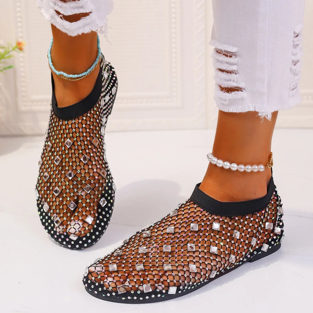 Women's flat sandals with mesh upper, colourful rhinestone design, and round toe on a rubber sole.