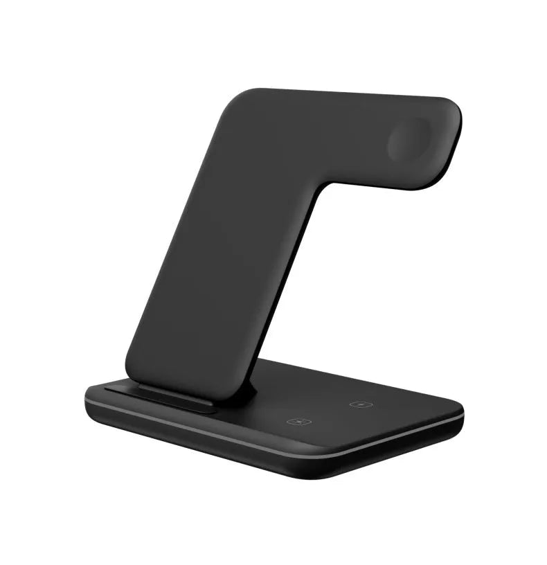 White three-in-one wireless charging stand for phone, watch, and headset on a desk.