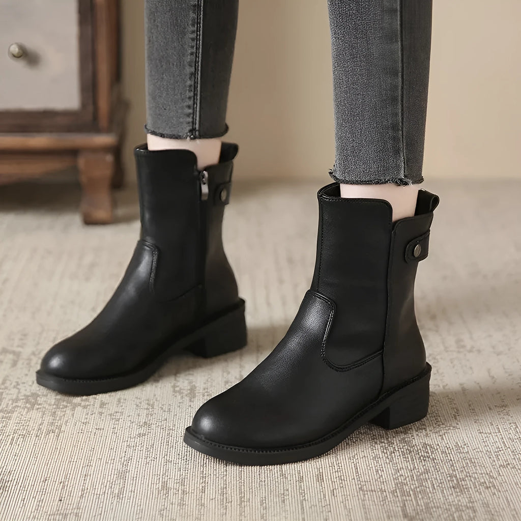 Black women's ankle boots with a side zip, round toe, and a low rubber sole.