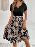 Khaki casual printed women's dress with A-line skirt, shoulder straps, and front lace-up detail.