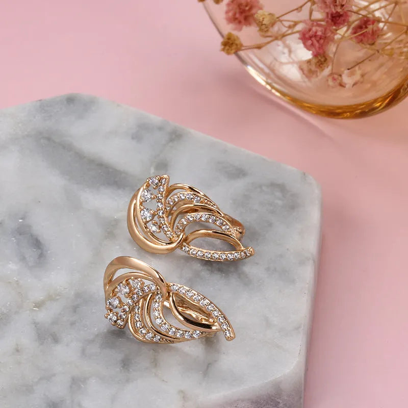 Gold geometric wing-shaped ear clips with micro inlaid stones on U-shaped copper clips