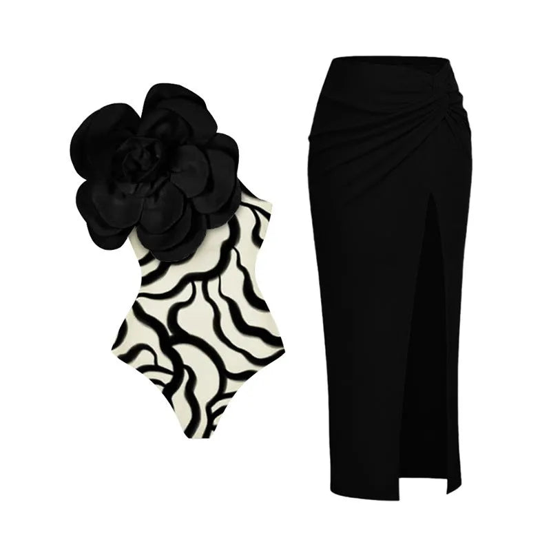 Black one-piece swimsuit with three-dimensional white floral pattern on a mannequin.