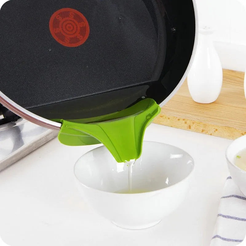 Green silicone kitchen funnel with clamp for round pots on kitchen counter