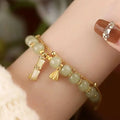 Bamboo style bracelet with electroplated coloured glass beads in a Ruyi flower design.