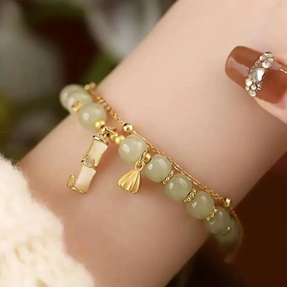 Bamboo style bracelet with electroplated coloured glass beads in a Ruyi flower design.