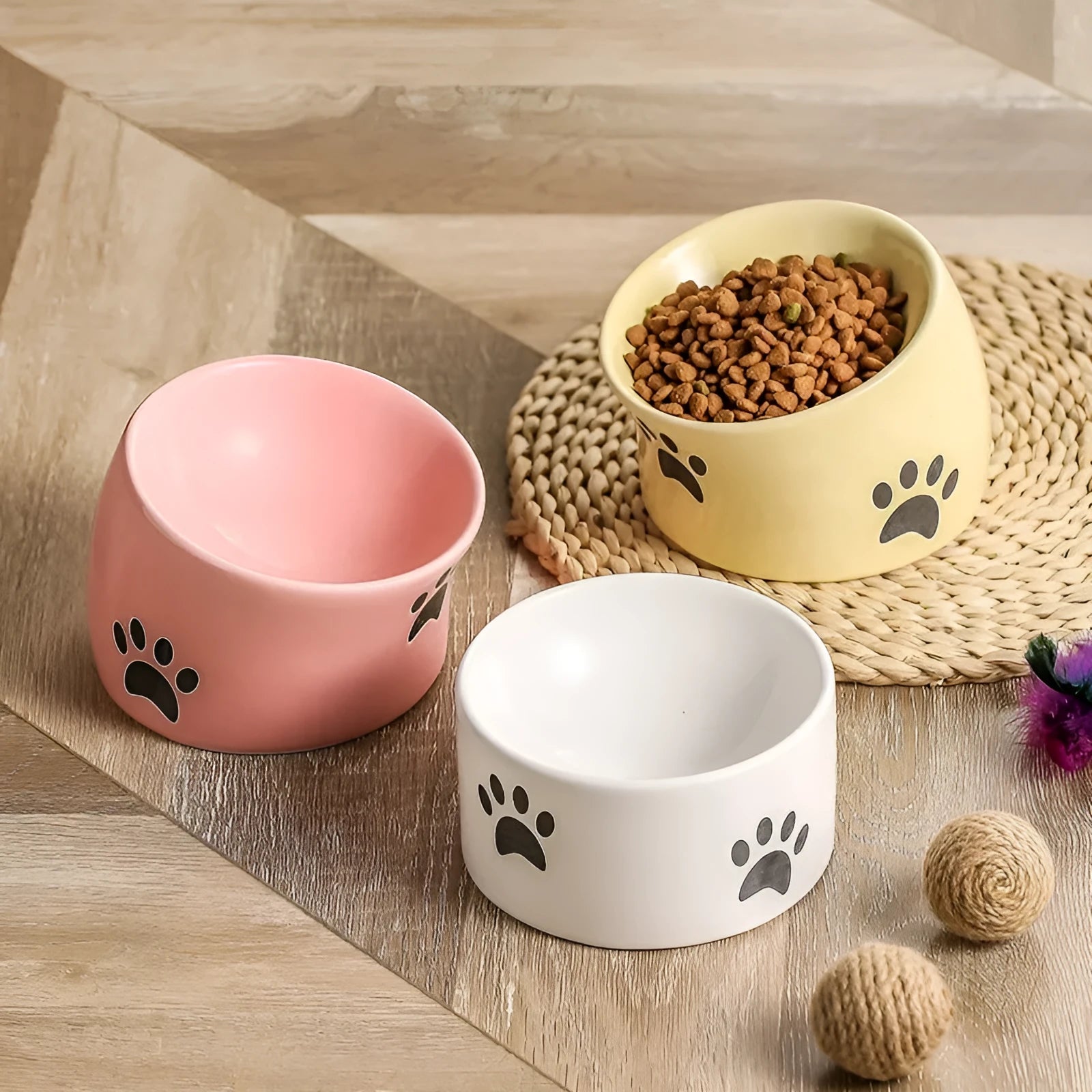 Ceramic cat food bowl with high foot design and cat's paw pattern in choice of colours