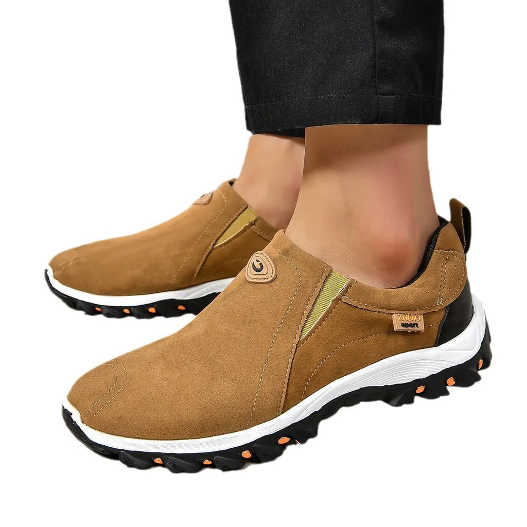 Men's thin oversleeve shoe cover in light brown with a round toe, shallow mouth, and rubber sole.