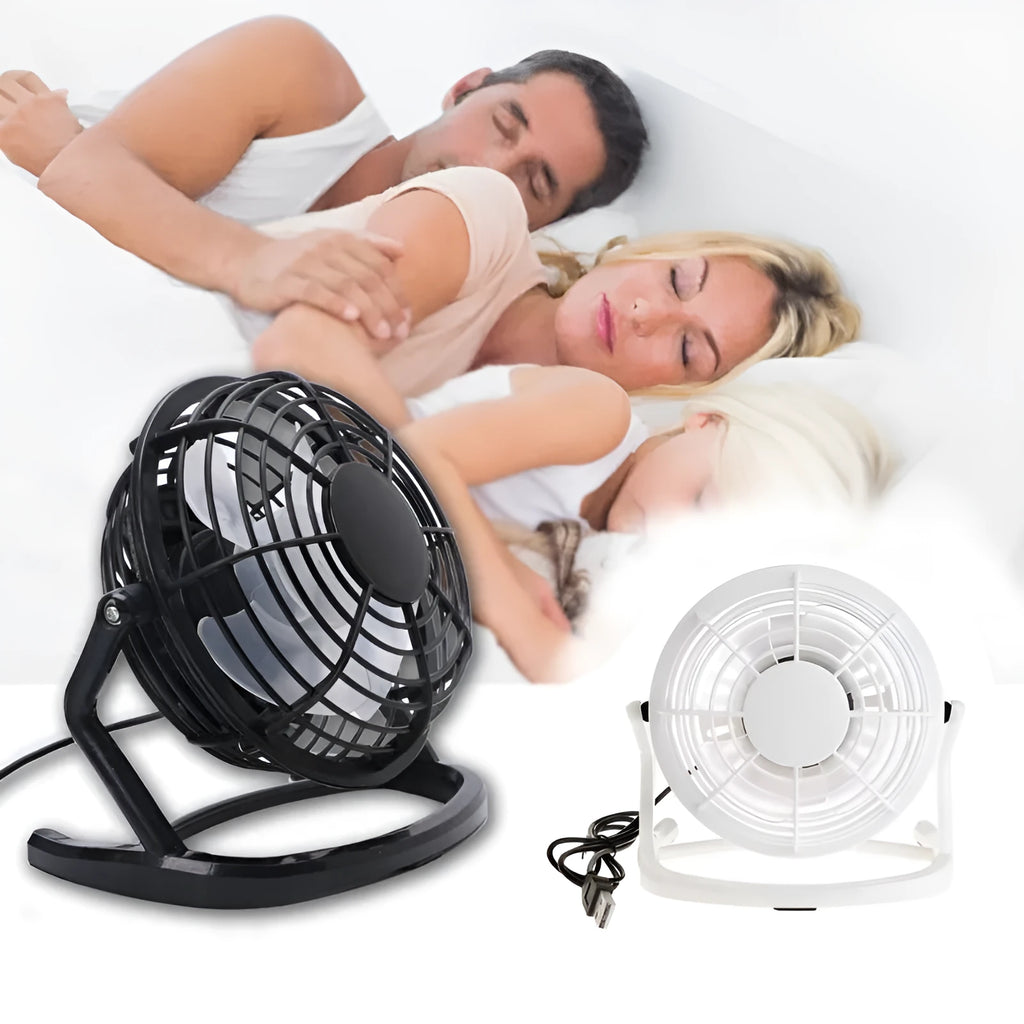 Mini portable USB desk fan with adjustable angle in black colour beside laptop