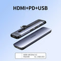 A compact USB dock expansion adapter with short cable, shown next to icons for HDMI, VGA, Ethernet, USB, and SD card ports.