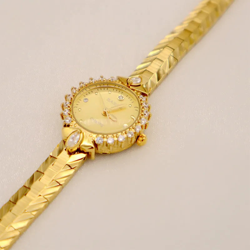 Vintage gold-toned ladies bracelet watch with diamond embossed links and quartz movement